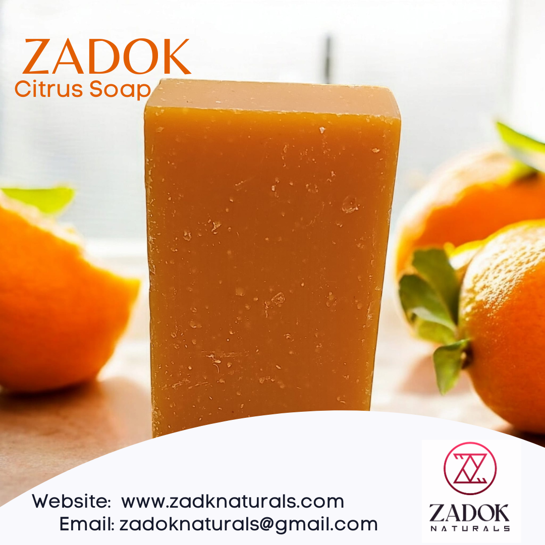 A bar of Citrus Lavender Soap with a background of oranges and orange slices, indicating the scent of the soap.