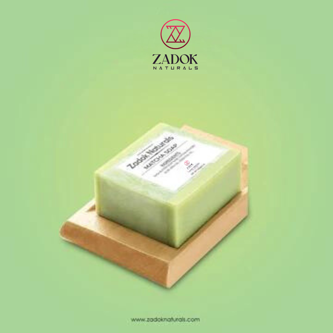 A bar of Matcha Soap on a wooden soap dish with a green label that includes the brand name 'Zadok's Naturous' and product details.