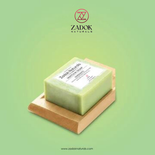 A bar of Matcha Soap on a wooden soap dish with a green label that includes the brand name 'Zadok's Naturous' and product details.